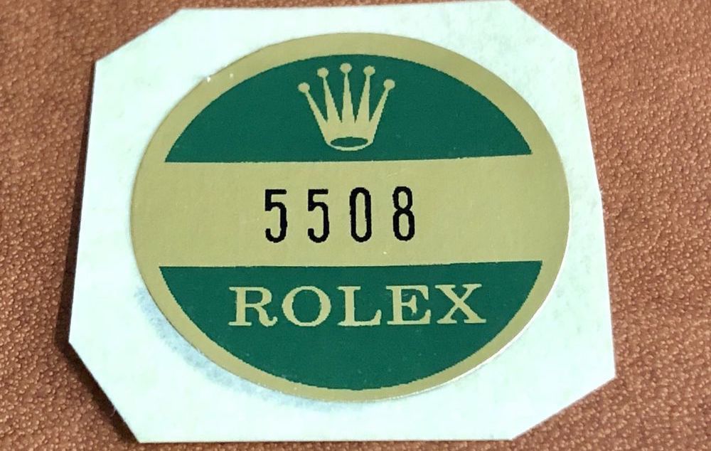 rolex with green sticker on back