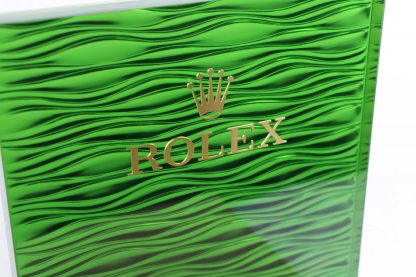 Rolex Original Watch Display Green Rolex Logo Background